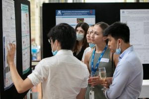 Students and staff observe scientific posters at the Amgen Scholars Program - Australia Symposium 2020.